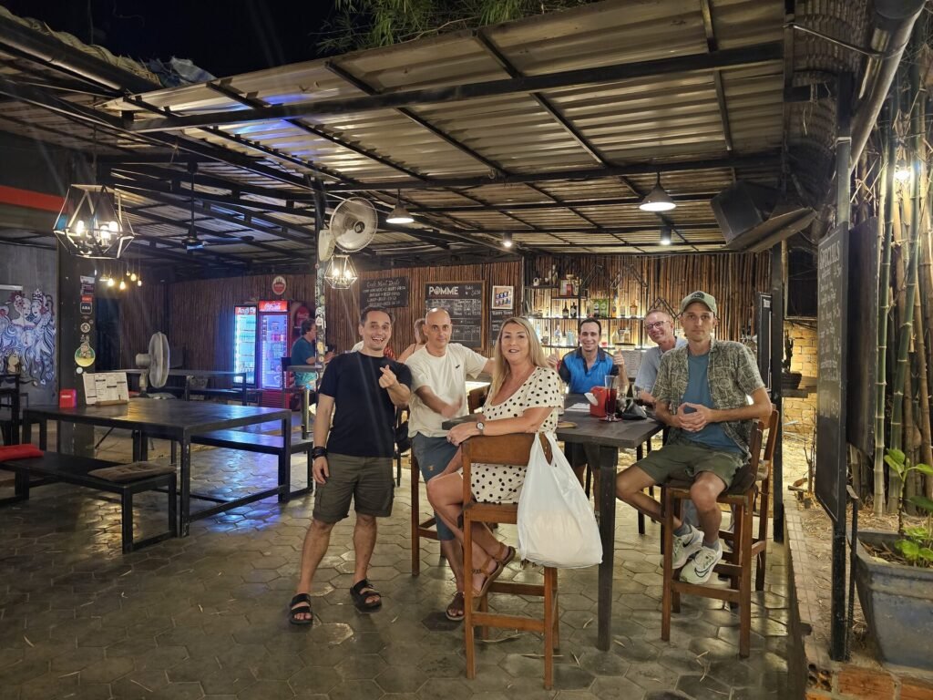 Siem Reap Social Club members around a bar table at a weekly meetup
